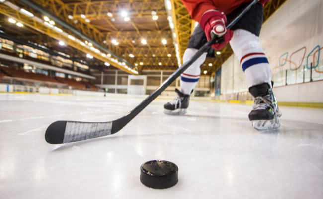 ice hockey, player with hockey stick and puck on ice